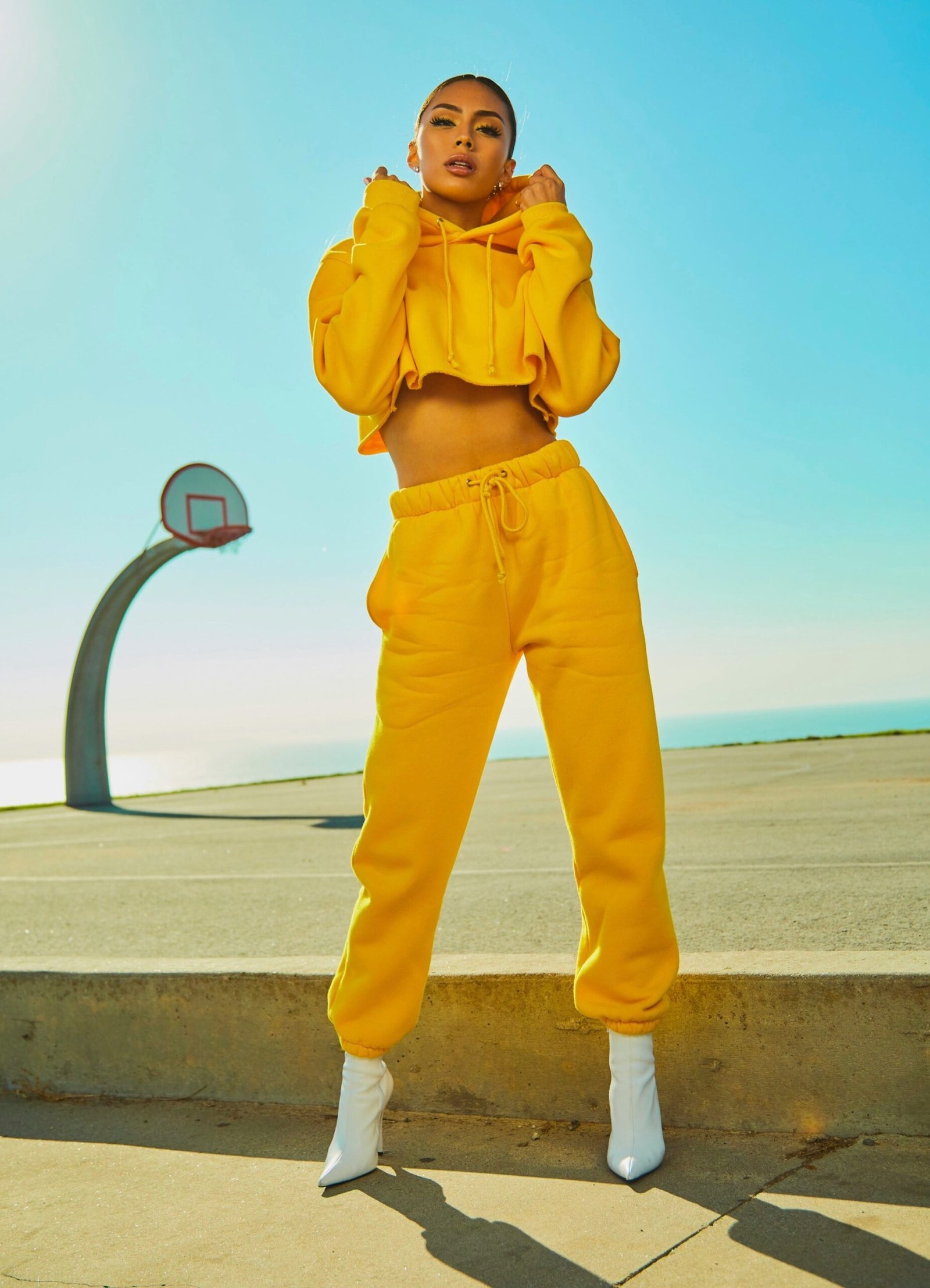 woman in yellow tracksuit standing on basketball court side